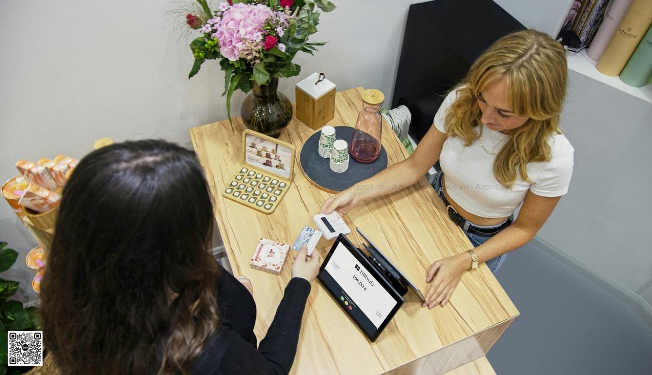 Quầy thu ngân cửa hàng nhỏ với máy POS và thao tác bán hàng